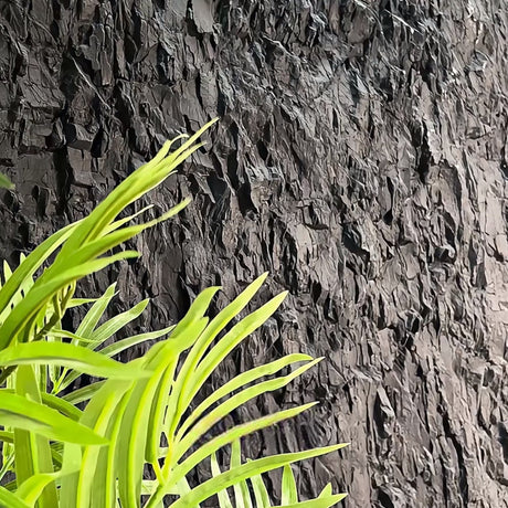 Close-up of a green plant against a textured dark background