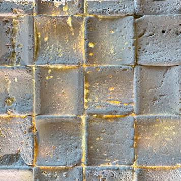 blacklit travertin mosaic with warm light
